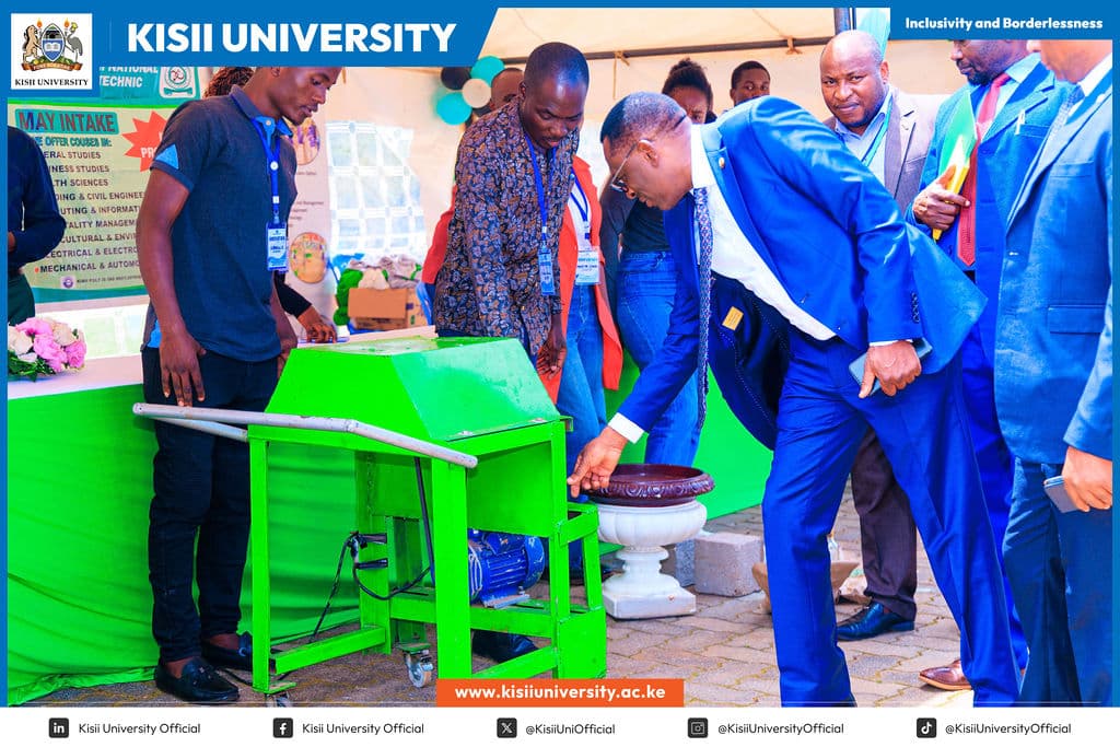 Visitors examining an innovation exhibit at Kisii University